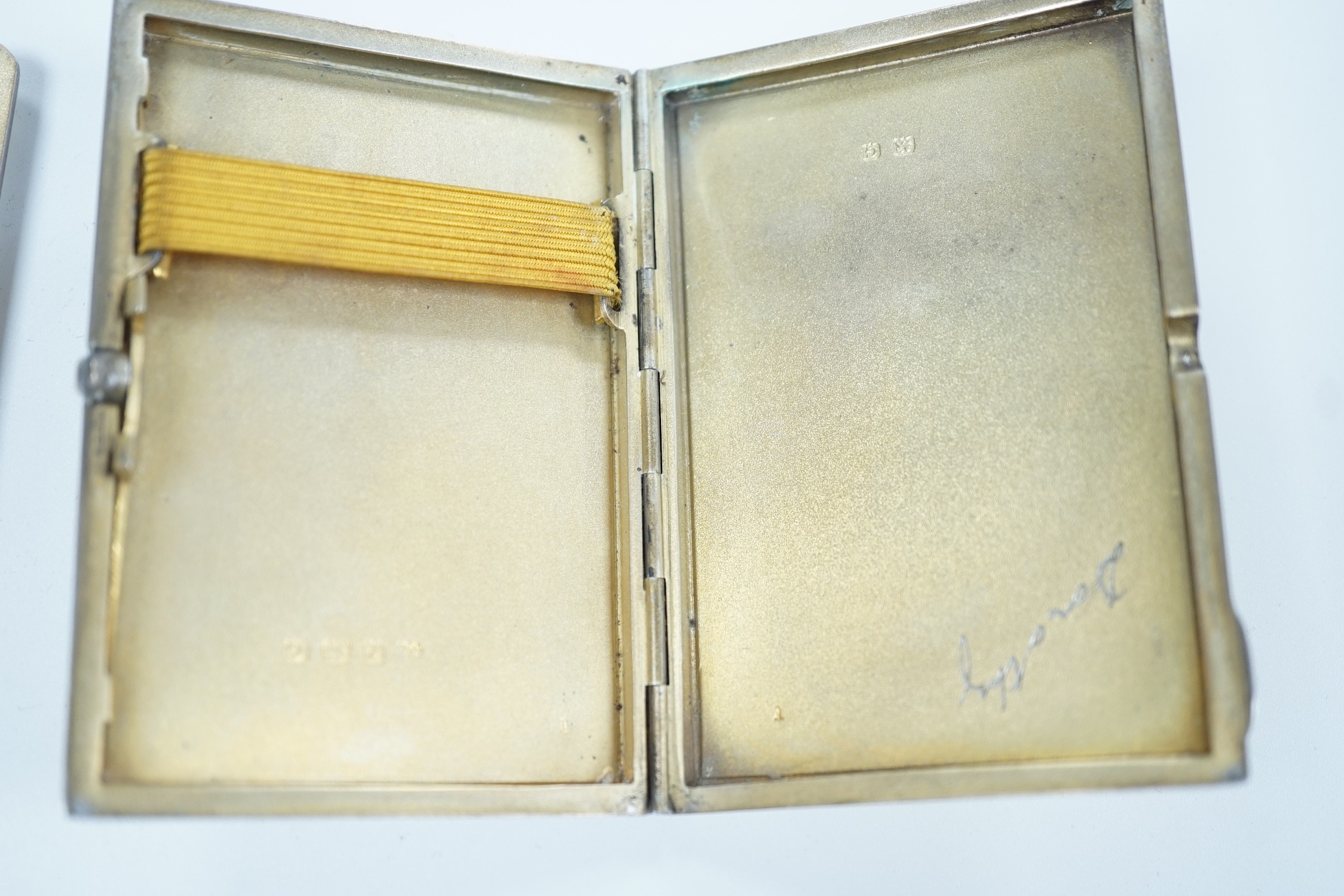 Two George V Art Deco silver and enamel cigarette cases, Birmingham, 1931 & 1932, largest 85mm (enamel a.f. on one) together with a German 800 standard white metal, cabochon emerald and rose cut diamond set compact/minau